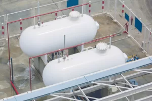 Two large white storage tanks seen from above.
